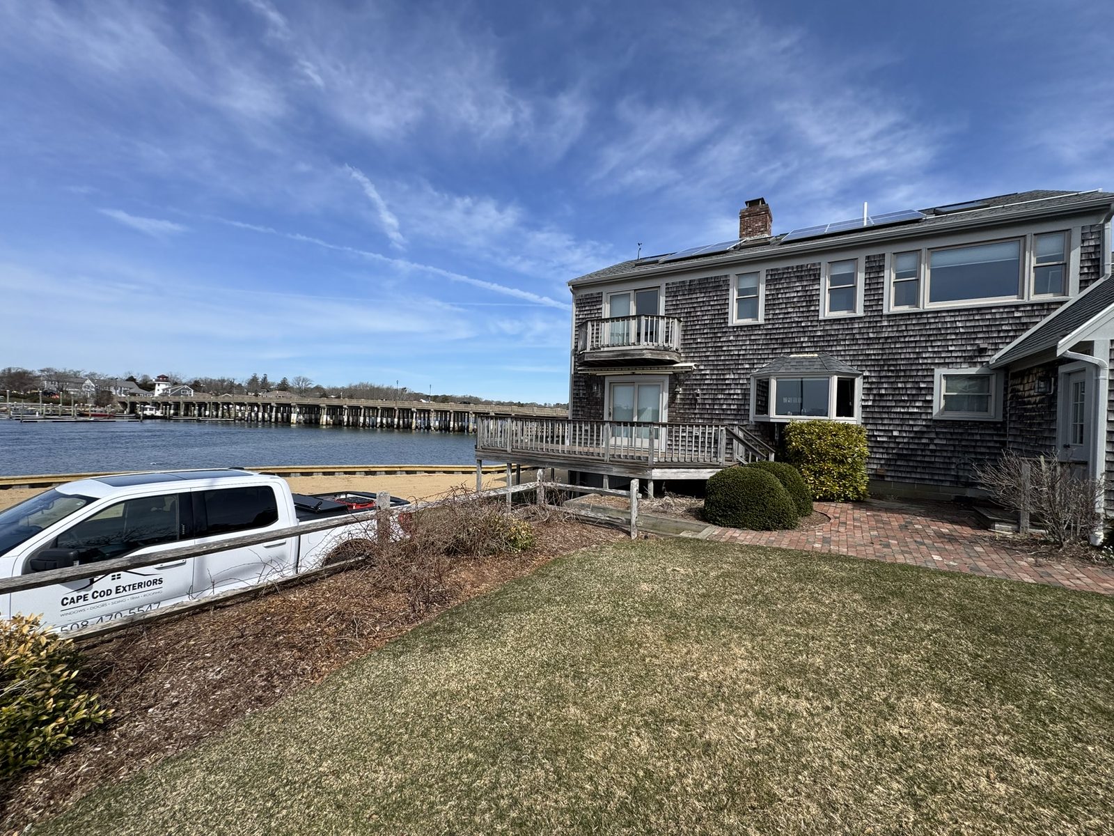 Waterfront Cape Cod shingle home with Cape Cod Exteriors truck